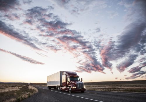 3/4 front view of a  commercial truck on the road at sunset  in eastern Washington, USA