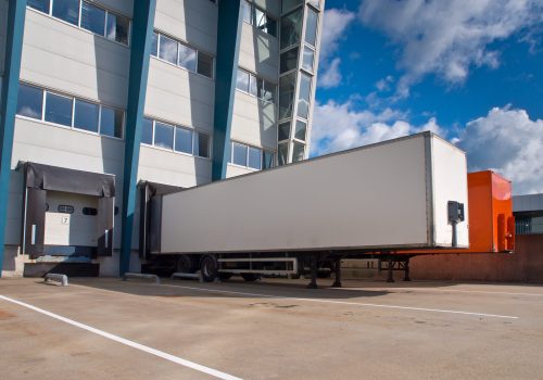 Red and White Trailer in Front of Docking Bay ready for Transport