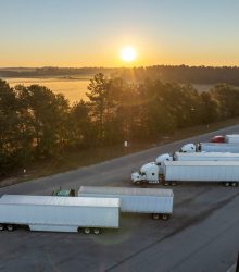 Rest area for semi trucks near busy interstate freeway. Truck stop place during hauling cargo.